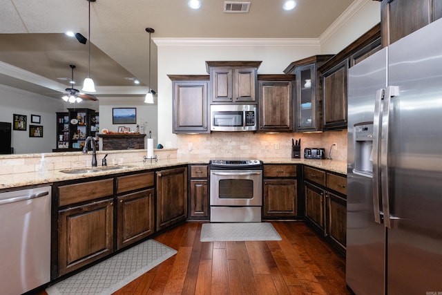 kitchen featuring appliances with stainless steel finishes, crown molding, dark hardwood / wood-style floors, and ceiling fan