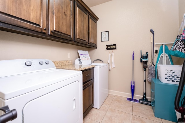 washroom featuring light tile patterned flooring, cabinets, and separate washer and dryer