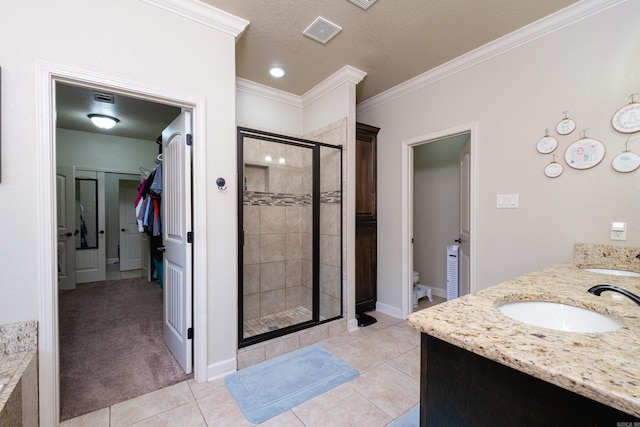 bathroom featuring a shower with door, tile patterned floors, ornamental molding, and vanity