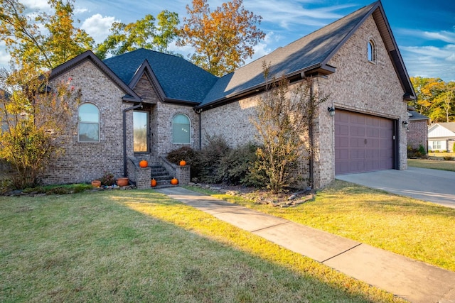 view of front of property with a front yard and a garage