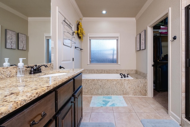 bathroom featuring vanity, a relaxing tiled tub, ornamental molding, and tile patterned flooring