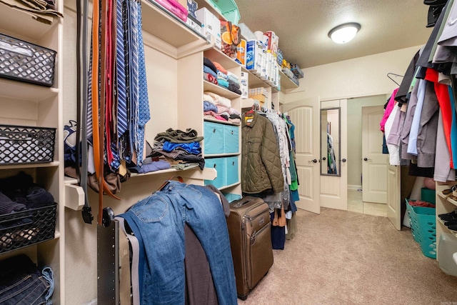 spacious closet featuring light carpet