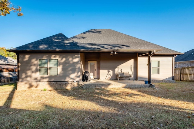 rear view of property with a patio area and a yard