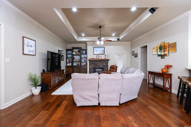 living room with crown molding, dark hardwood / wood-style floors, and a raised ceiling