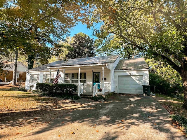 ranch-style home with a porch and a garage