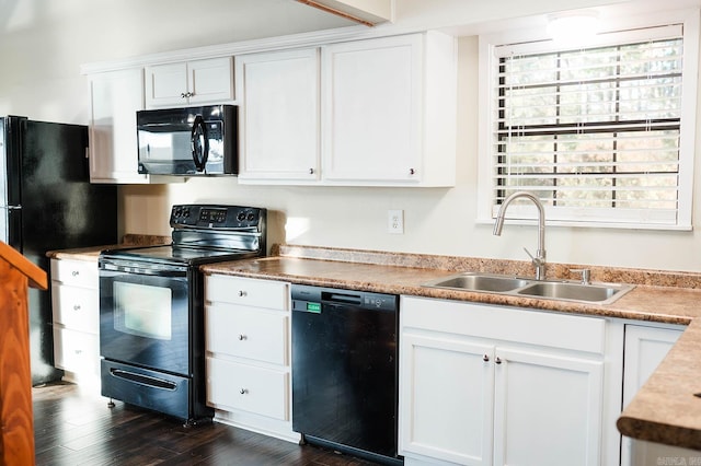 kitchen with white cabinetry, black appliances, sink, and dark hardwood / wood-style flooring