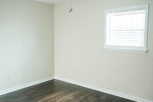 empty room with dark hardwood / wood-style flooring