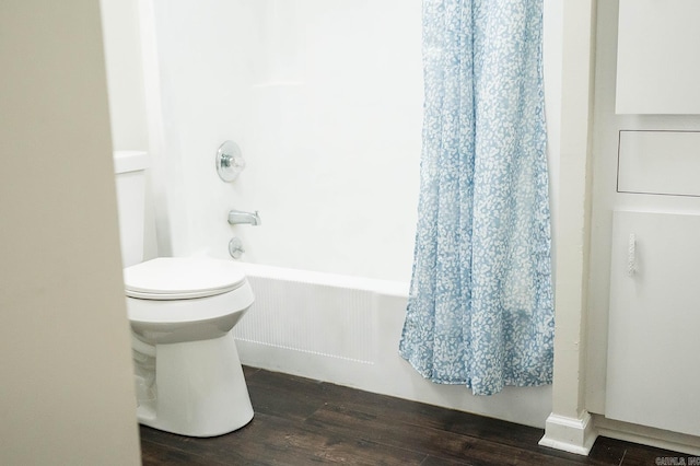 bathroom featuring shower / bath combination with curtain, toilet, and hardwood / wood-style floors