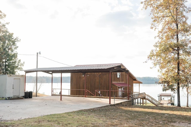 view of outdoor structure featuring a water view and a carport