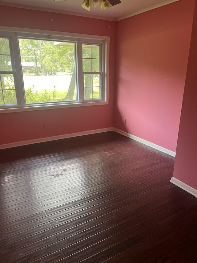 spare room featuring ceiling fan, ornamental molding, and dark hardwood / wood-style flooring