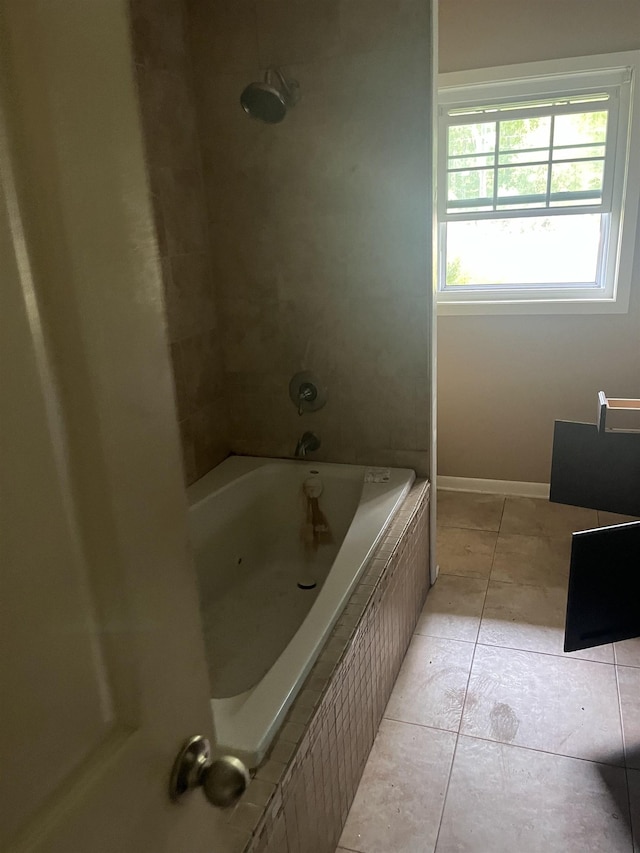 bathroom with tiled shower / bath and tile patterned floors