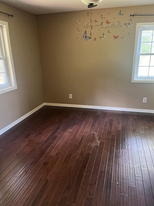 unfurnished room featuring dark hardwood / wood-style flooring