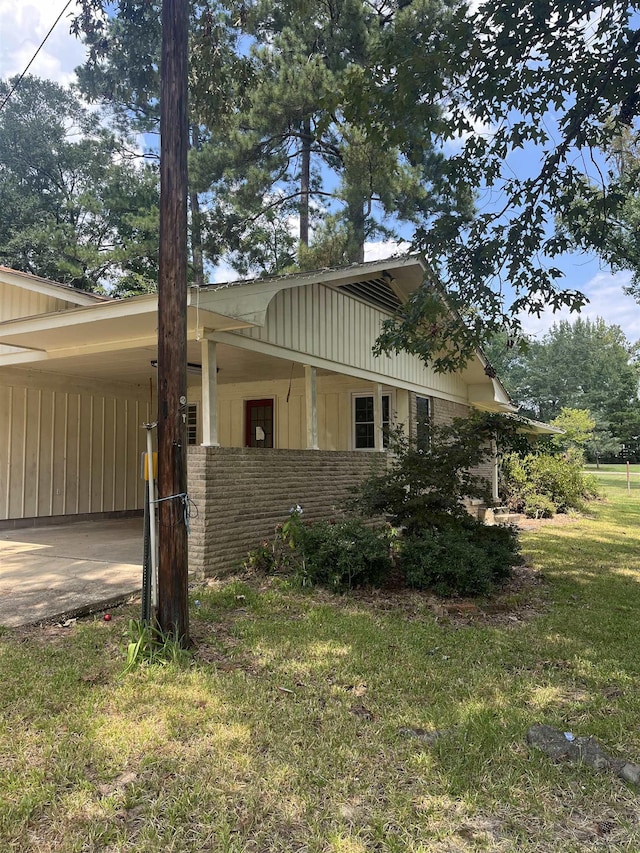 view of home's exterior featuring a carport and a yard