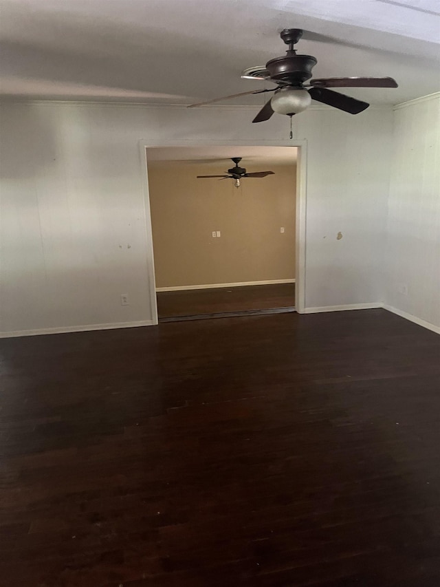 empty room featuring crown molding, ceiling fan, and dark hardwood / wood-style flooring