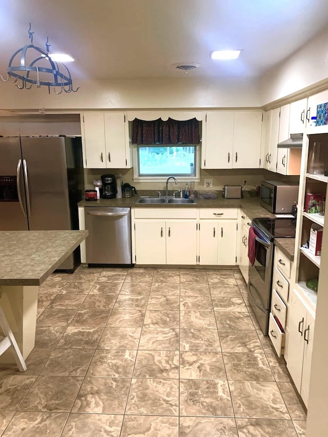 kitchen with sink, appliances with stainless steel finishes, and white cabinets