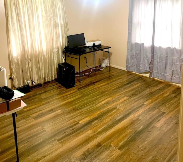 home office with wood-type flooring