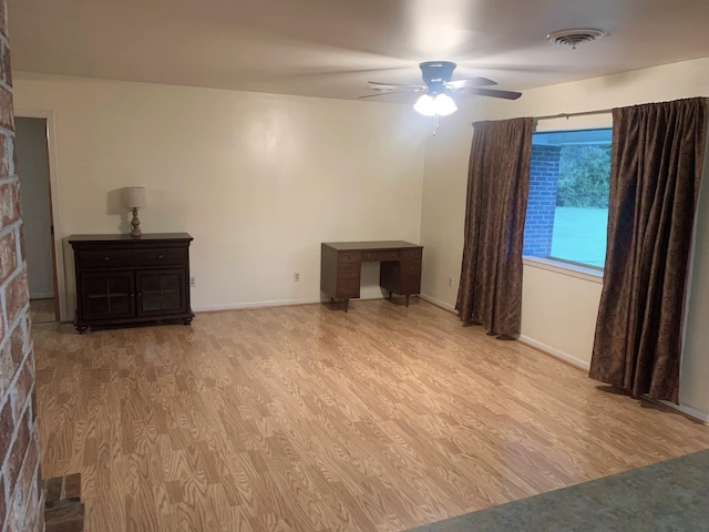 unfurnished living room featuring light hardwood / wood-style flooring and ceiling fan