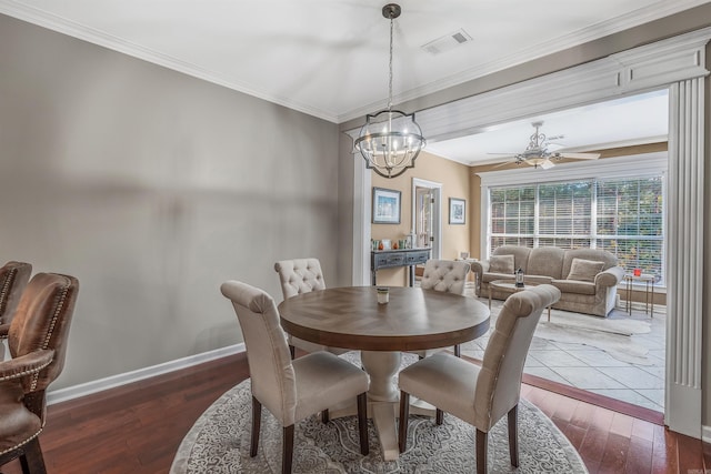 dining room with ornamental molding, dark hardwood / wood-style floors, and ceiling fan with notable chandelier