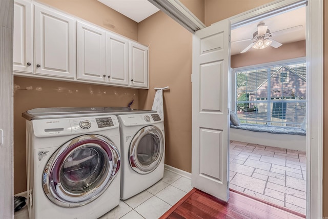 laundry area featuring cabinets, light hardwood / wood-style flooring, washer and clothes dryer, and ceiling fan