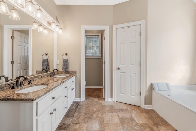 bathroom with vanity and a tub to relax in