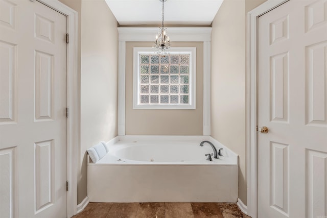 bathroom with an inviting chandelier and a washtub