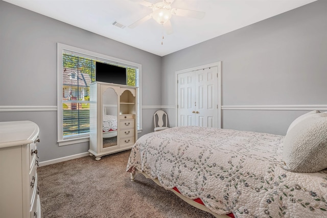 carpeted bedroom with a closet and ceiling fan