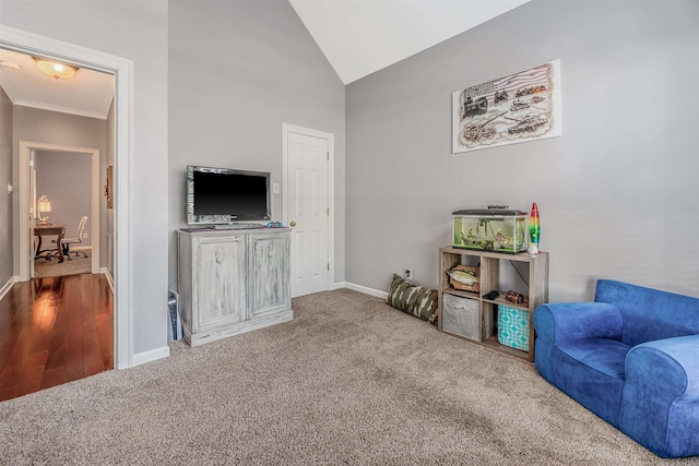 living area with crown molding, carpet, and vaulted ceiling