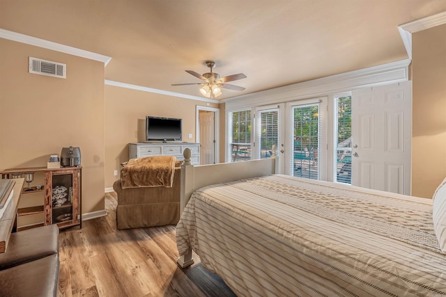 bedroom featuring french doors, access to exterior, hardwood / wood-style floors, crown molding, and ceiling fan