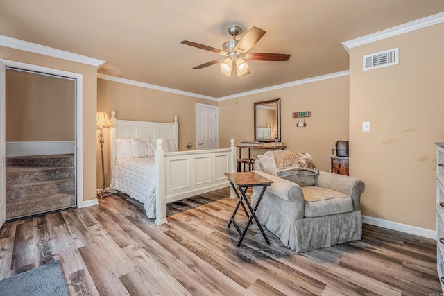 bedroom featuring ceiling fan, ornamental molding, and light wood-type flooring