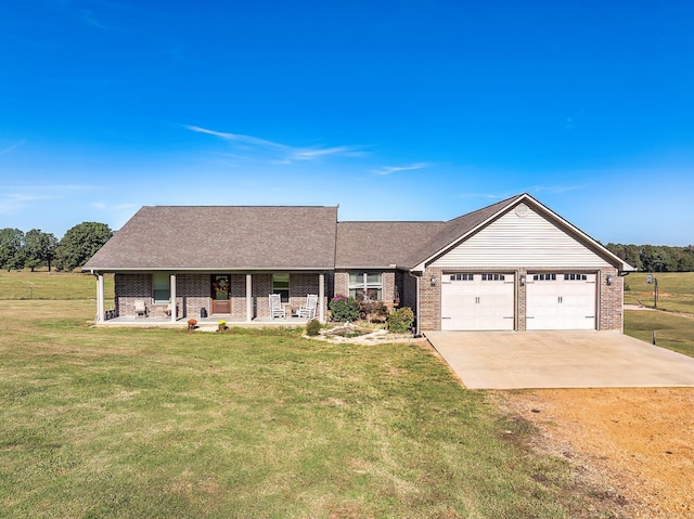 ranch-style house featuring a porch, a front lawn, and a garage