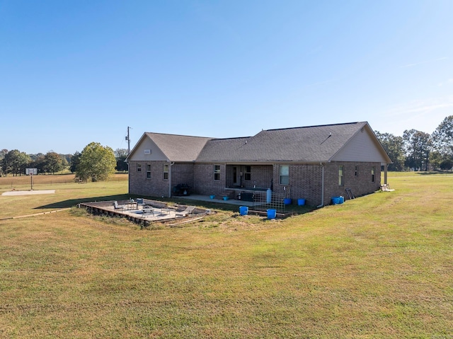 back of house featuring a patio and a lawn