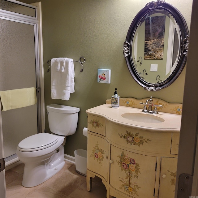 bathroom with vanity, toilet, and tile patterned floors