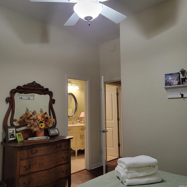 bedroom with connected bathroom, ceiling fan, and wood-type flooring