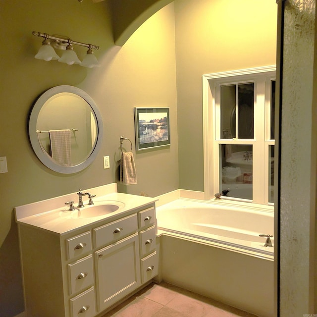 bathroom featuring vanity, tile patterned flooring, and a bathing tub