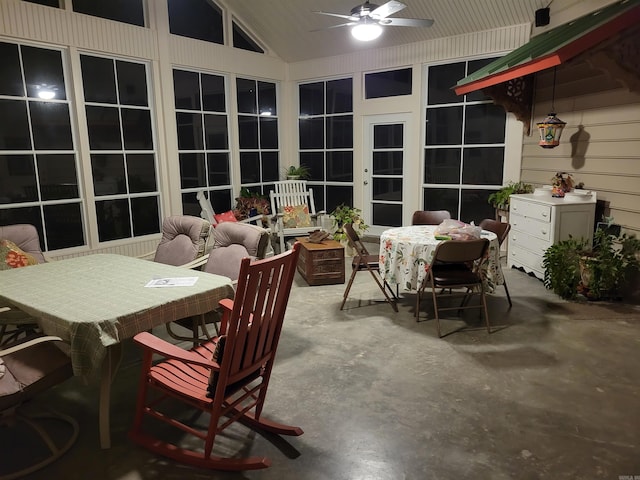 sunroom with ceiling fan and vaulted ceiling