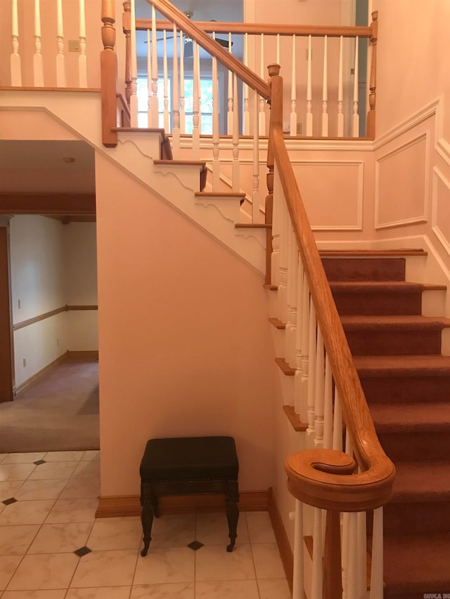 stairs featuring tile patterned floors