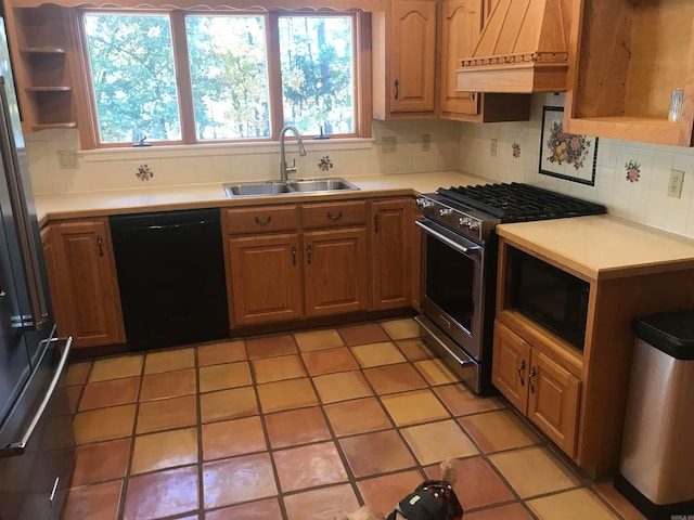 kitchen with black dishwasher, sink, high end stove, custom range hood, and decorative backsplash