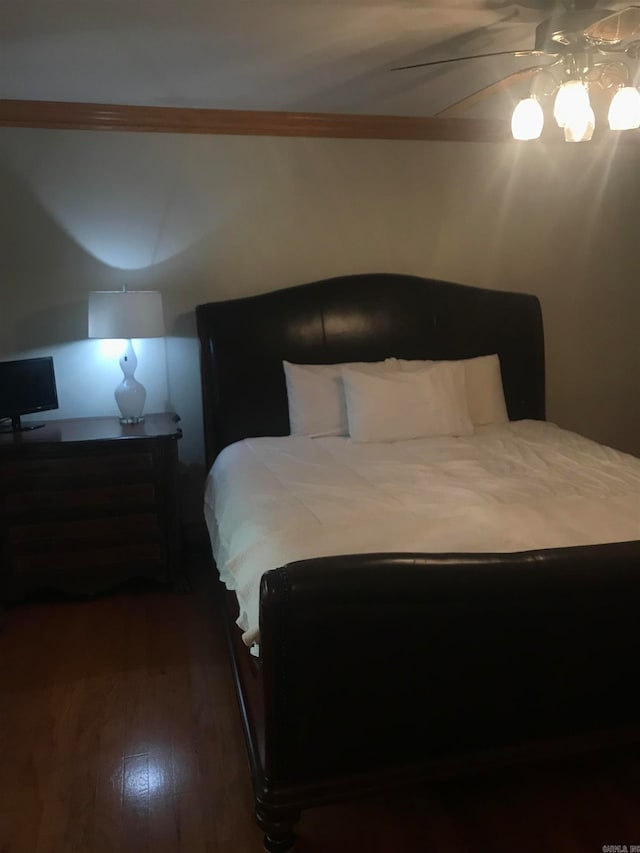 bedroom with ceiling fan and dark hardwood / wood-style flooring