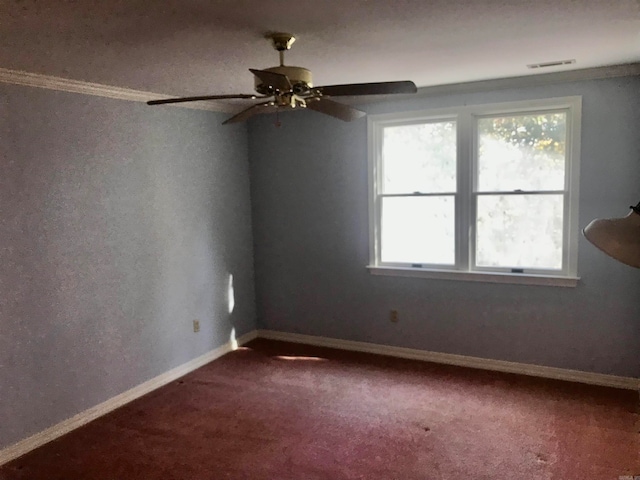 carpeted empty room featuring ceiling fan and crown molding