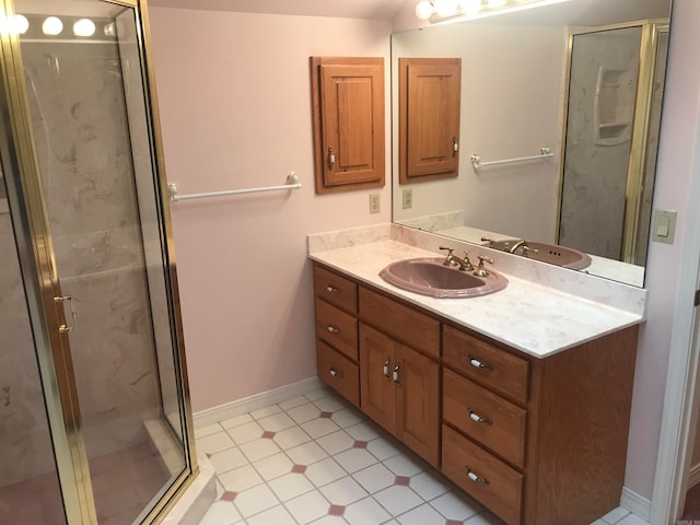 bathroom featuring vanity, a shower with shower door, and tile patterned flooring