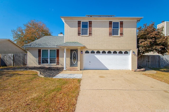 front facade featuring a front yard and a garage