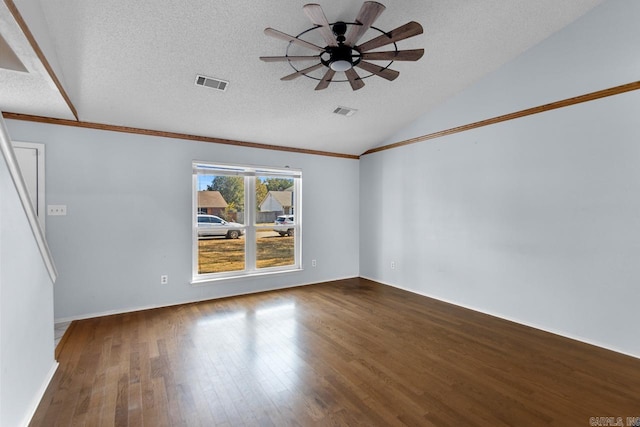 spare room featuring lofted ceiling, wood-type flooring, ornamental molding, a textured ceiling, and ceiling fan