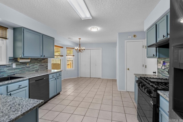 kitchen featuring black appliances, light tile patterned flooring, backsplash, a textured ceiling, and pendant lighting