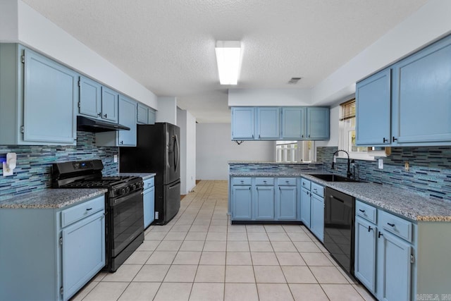 kitchen with black appliances, sink, a textured ceiling, decorative backsplash, and light tile patterned floors