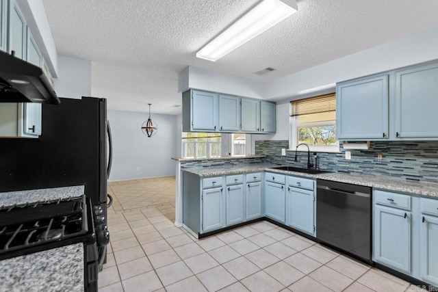 kitchen with sink, black appliances, light tile patterned floors, blue cabinets, and tasteful backsplash