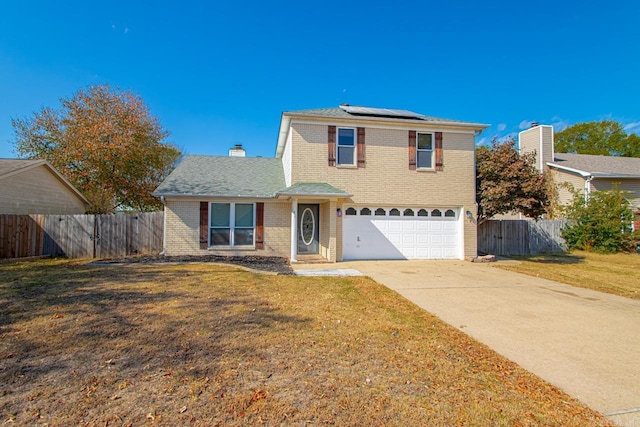 view of property featuring a front yard, a garage, and solar panels