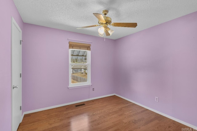 unfurnished room featuring a textured ceiling, wood-type flooring, and ceiling fan