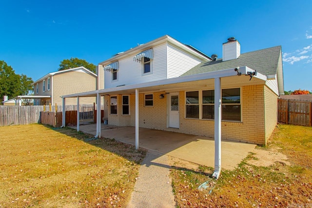 rear view of house with a patio area and a lawn