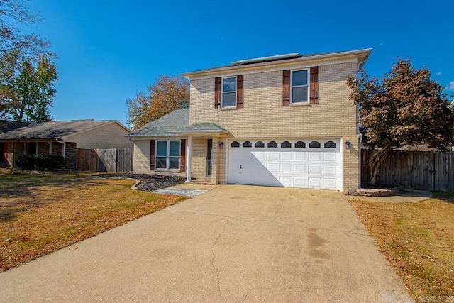 front facade with a front yard and a garage