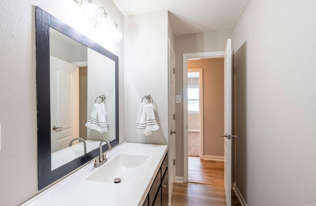 bathroom featuring vanity and hardwood / wood-style flooring